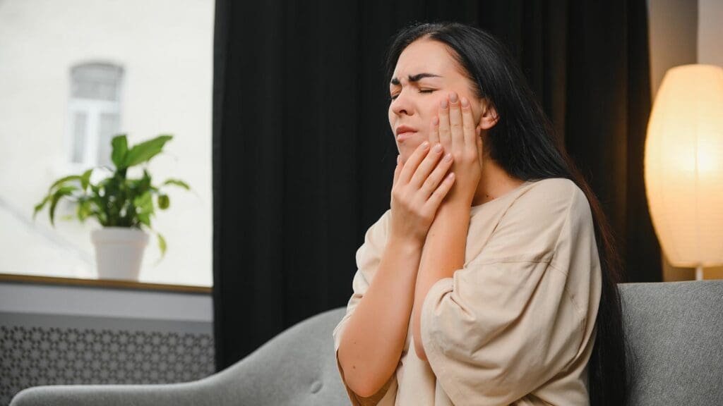 Person experiencing jaw tension and a temple headache in Langley